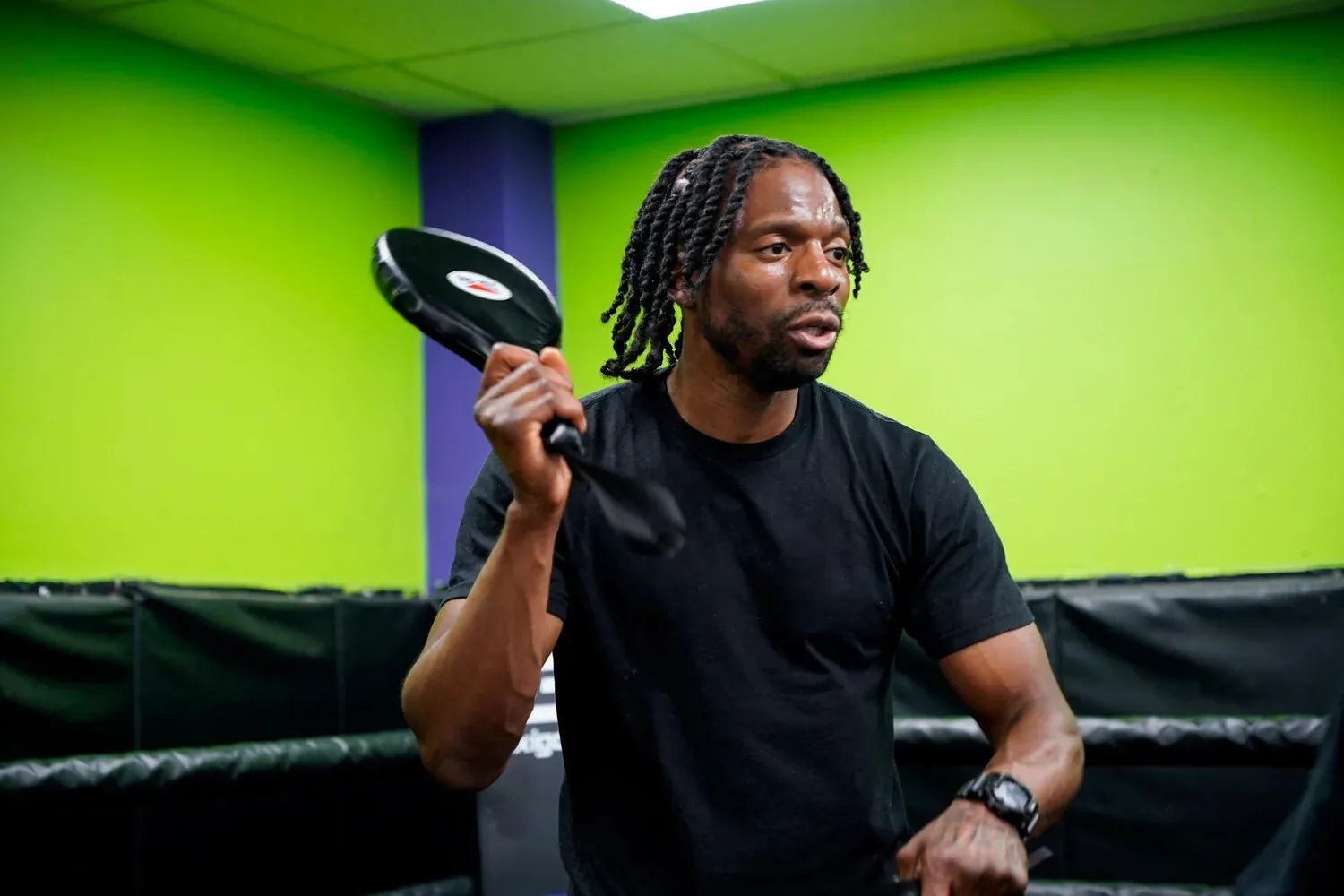 Coach holding pads during an amateur boxing session