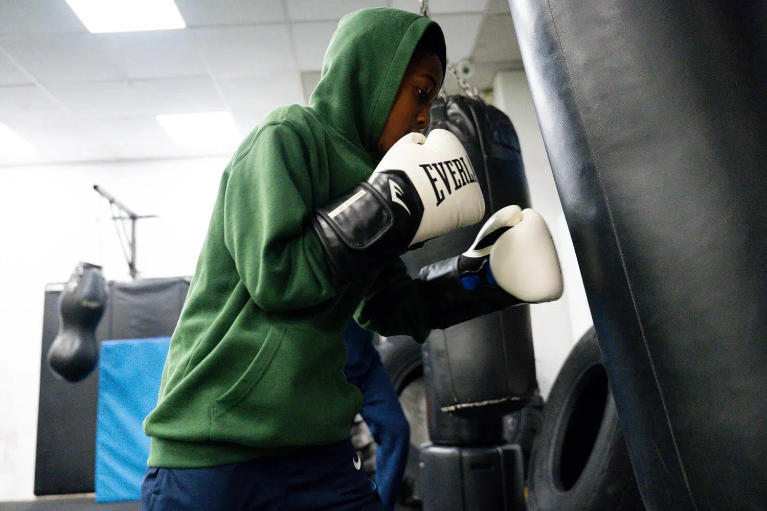 Boxer working a heavy bag at FFLY Boxing Club