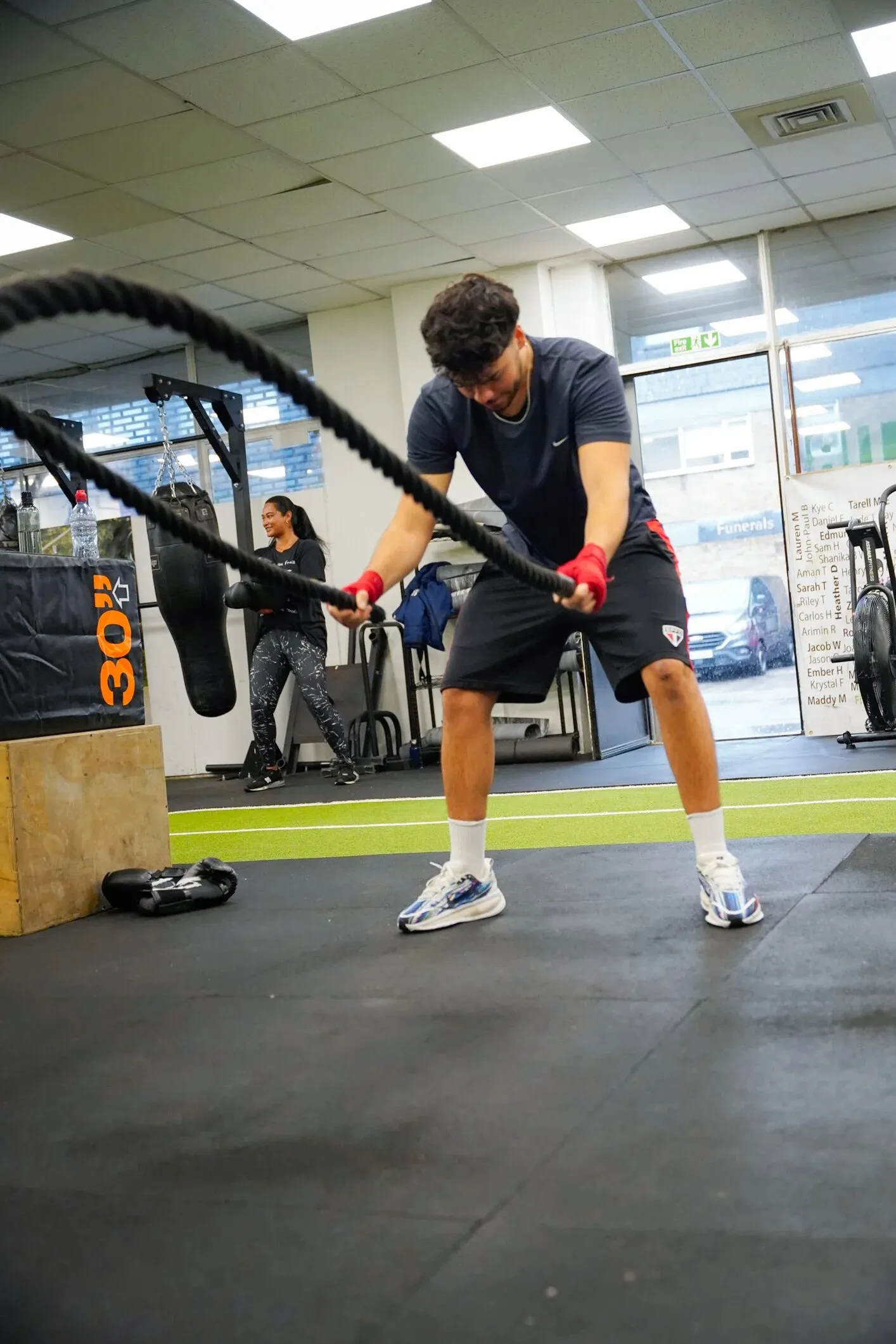 Battle ropes session on the gym floor