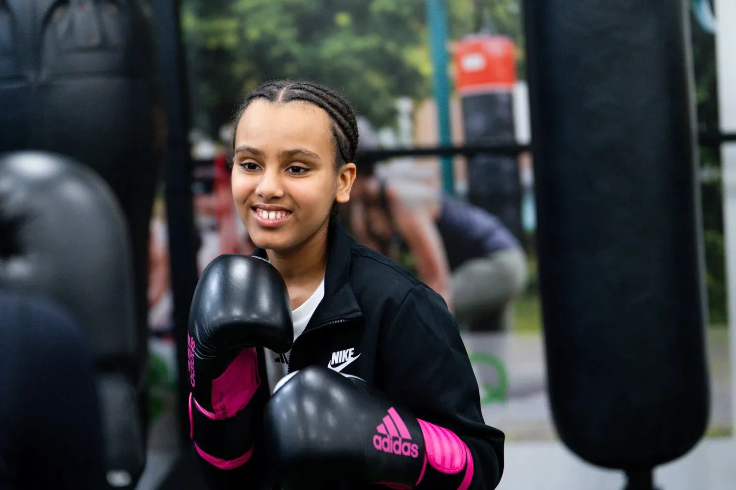 Young member smiling in boxing gloves